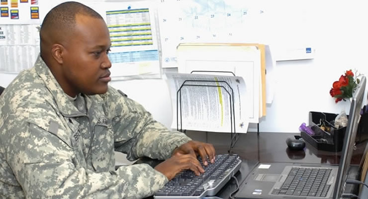Soldier works on computer
